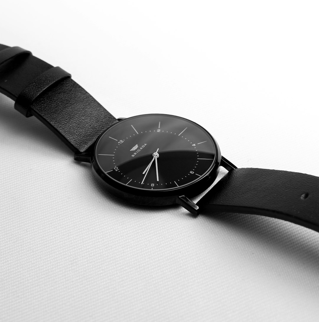 A black minimalist watch with a leather strap